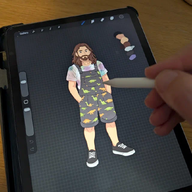 iPad display showing Procreate workspace with the character illustration in progress: a bearded person in a pastel striped T-shirt and yellow-green dinosaur-print shorts, with colour palette and canvas tools visible.